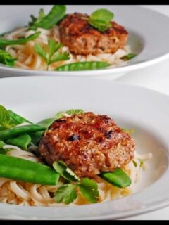 Thai turkey meatballs with noodles and green peas.