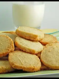 A plate of Coconut Butter Thins cookies and a glass of milk.