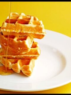 Indulge in a plate of brown butter waffles drizzled with golden syrup.