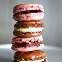 Four French Macarons stacked on top of each other.