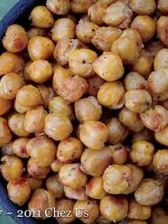 Roasted curry chickpeas in a bowl on a table.