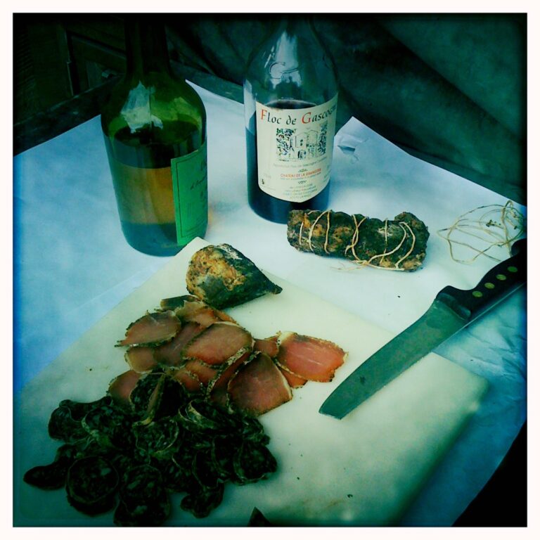 A knife on a cutting board next to a bottle of wine in Gascony, France.