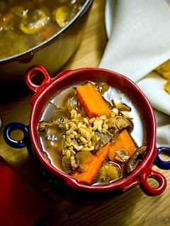 An appetizing bowl of Porcini Barley Soup on a rustic table.