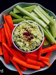 A plate with carrots, celery and hummus served with Meyer Lemon Dip.
