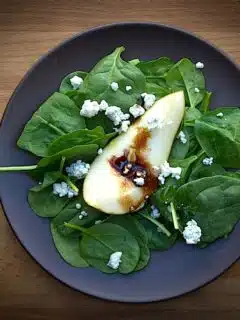Indulge in a delicious fall pear salad with blue cheese and balsamic vinaigrette.
