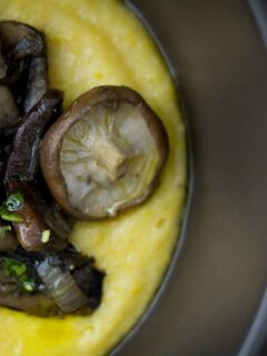Creamy polenta topped with flavorful mushroom ragout and fresh parsley.