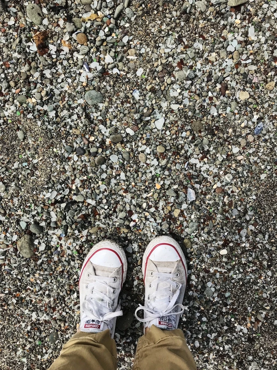 Mendocino beach with rocks and feet.