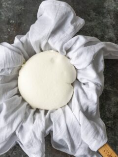 A white cloth with a ball of homemade labneh cheese on it.